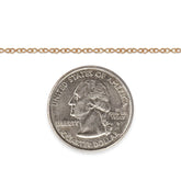 Gold-filled infinity chain next to a quarter dollar coin for scale on a white background